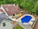 Inviting in-ground pool and deck with outdoor seating, perfect for entertaining, nestled among mature trees at 400 N Peachtree Pkwy, Peachtree City, GA 30269