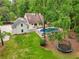 Spacious yard with a trampoline and in-ground pool, providing a perfect outdoor living space surrounded by green foliage at 400 N Peachtree Pkwy, Peachtree City, GA 30269