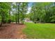 Large backyard with a view of the home, patio and yard at 400 N Peachtree Pkwy, Peachtree City, GA 30269
