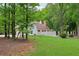 Large backyard with a view of the home, patio and yard at 400 N Peachtree Pkwy, Peachtree City, GA 30269