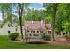 Well-maintained backyard with an in-ground pool, a trampoline, and a charming deck, perfect for outdoor enjoyment at 400 N Peachtree Pkwy, Peachtree City, GA 30269