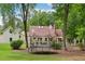 A large backyard with a home, patio and trampoline at 400 N Peachtree Pkwy, Peachtree City, GA 30269