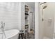 Bathroom featuring a soaking tub, built-in shelves, and tiled shower with neutral tones at 400 N Peachtree Pkwy, Peachtree City, GA 30269