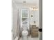 Bathroom with a toilet, sink, walk-in shower, and window at 400 N Peachtree Pkwy, Peachtree City, GA 30269