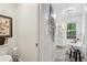 Bright bathroom featuring a soaking tub, and shower. The space also features shiplap and a beaded chandelier at 400 N Peachtree Pkwy, Peachtree City, GA 30269