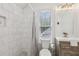 Bathroom with a white tiled shower, window, modern vanity, and elegant fixtures at 400 N Peachtree Pkwy, Peachtree City, GA 30269