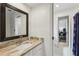 Neutral bathroom with a granite countertop, square mirror and white cabinets at 400 N Peachtree Pkwy, Peachtree City, GA 30269