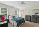 Bedroom with a ceiling fan, large window, two dressers, and neutral-colored carpet at 400 N Peachtree Pkwy, Peachtree City, GA 30269