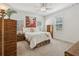 Cozy bedroom with neutral tones, soft carpet, and vintage wood furniture at 400 N Peachtree Pkwy, Peachtree City, GA 30269
