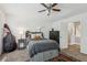 Comfortable bedroom featuring a ceiling fan, large bed, and neutral carpet at 400 N Peachtree Pkwy, Peachtree City, GA 30269