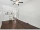 Bonus room with dark hardwood floors, ceiling fan, and built-in shelves at 400 N Peachtree Pkwy, Peachtree City, GA 30269