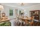 Elegant dining room with a wood table set for six, with natural lighting and built-in cabinets at 400 N Peachtree Pkwy, Peachtree City, GA 30269