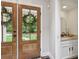 Inviting entryway with double doors and convenient access to a stylish powder room at 400 N Peachtree Pkwy, Peachtree City, GA 30269