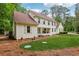 Charming two-story home with a well-manicured lawn and lush landscaping, offering curb appeal and serene surroundings at 400 N Peachtree Pkwy, Peachtree City, GA 30269