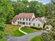 Beautiful two-story home with a well-manicured lawn and mature trees, offering a warm and inviting atmosphere at 400 N Peachtree Pkwy, Peachtree City, GA 30269