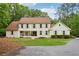 Charming two-story traditional home with a welcoming front porch, lush lawn, and mature trees at 400 N Peachtree Pkwy, Peachtree City, GA 30269