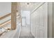 Upstairs hallway featuring a wooden beam and a view of the kitchen with ample closet space at 400 N Peachtree Pkwy, Peachtree City, GA 30269