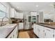 Well-lit kitchen with stainless steel appliances, dark countertops, and white cabinetry at 400 N Peachtree Pkwy, Peachtree City, GA 30269