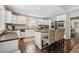 Bright kitchen featuring white cabinets, a central island, and updated stainless appliances at 400 N Peachtree Pkwy, Peachtree City, GA 30269