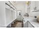 Modern laundry room featuring granite countertops, a washer and dryer, and built-in storage shelves at 400 N Peachtree Pkwy, Peachtree City, GA 30269