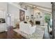 Bright living room featuring a vaulted ceiling, brick fireplace, and large windows with views of the backyard at 400 N Peachtree Pkwy, Peachtree City, GA 30269