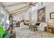 Open-concept living room with high ceilings, exposed beams, and plenty of natural light at 400 N Peachtree Pkwy, Peachtree City, GA 30269