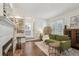 Cozy living room featuring hardwood floors, a fireplace with built-in shelving, and stylish decor at 400 N Peachtree Pkwy, Peachtree City, GA 30269