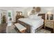 Cozy bedroom with a large bed, area rug, and rustic wood furniture at 400 N Peachtree Pkwy, Peachtree City, GA 30269