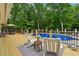 Relax poolside on a spacious deck with comfortable seating and lush greenery at 400 N Peachtree Pkwy, Peachtree City, GA 30269