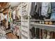 Organized walk-in closet with hanging racks, drawers, and shelves for efficient storage at 400 N Peachtree Pkwy, Peachtree City, GA 30269