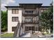 Multi-level balconies highlight the rear exterior of this modern home with stairs leading to the landscaped yard at 4109 Abbotts Bridge Rd, Duluth, GA 30097