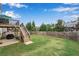 Landscaped backyard has wood fence, deck with stairs, patio with grill, and plenty of green space at 704 Woodbridge Dr, Woodstock, GA 30188
