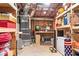 Unfinished basement with exposed ceiling and wood shelving for storage at 704 Woodbridge Dr, Woodstock, GA 30188