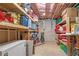 Unfinished basement storage area with open shelving and storage containers at 704 Woodbridge Dr, Woodstock, GA 30188