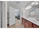 The bathroom has double sinks and a view into the light and airy bedroom at 704 Woodbridge Dr, Woodstock, GA 30188