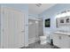 Stylish bathroom features blue walls, patterned floor tiles, glass shower, and vanity sink at 704 Woodbridge Dr, Woodstock, GA 30188