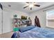 Cozy bedroom with a ceiling fan, a computer desk, and natural light from the window at 704 Woodbridge Dr, Woodstock, GA 30188