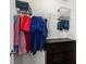 Organized walk-in closet featuring hanging rods, shelving, and a dark dresser at 704 Woodbridge Dr, Woodstock, GA 30188
