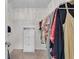 This walk-in closet offers metal shelving and plenty of space to hang clothing at 704 Woodbridge Dr, Woodstock, GA 30188