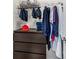 Well-organized closet with a variety of hanging clothes and a dark dresser at 704 Woodbridge Dr, Woodstock, GA 30188
