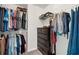 This walk-in closet features wire shelving, drawers, and ample room to hang clothing at 704 Woodbridge Dr, Woodstock, GA 30188