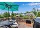 Enjoy this outdoor deck with dining set, grill, and views of a tree-lined backyard at 704 Woodbridge Dr, Woodstock, GA 30188