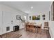 Bright dining room features wood floors, a wooden table, a flat screen tv, and a telescope at 704 Woodbridge Dr, Woodstock, GA 30188