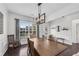 Open dining area with wood floors, natural light, and a view of the kitchen at 704 Woodbridge Dr, Woodstock, GA 30188