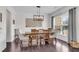 Stylish dining room with modern decor, wood floors, and a window view at 704 Woodbridge Dr, Woodstock, GA 30188