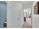 This hallway leads to a bedroom, showing the carpeted floor and neutral-painted walls at 704 Woodbridge Dr, Woodstock, GA 30188