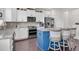 Bright kitchen featuring stainless appliances, white cabinets, and a blue kitchen island with barstool seating at 704 Woodbridge Dr, Woodstock, GA 30188