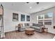Cozy living room with a sectional sofa, a wooden coffee table, and natural light from the window at 704 Woodbridge Dr, Woodstock, GA 30188