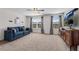Bright and cozy living room featuring a sofa and multiple windows for ample light at 704 Woodbridge Dr, Woodstock, GA 30188
