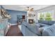 Comfortable living room featuring a fireplace, television and sectional sofa at 704 Woodbridge Dr, Woodstock, GA 30188